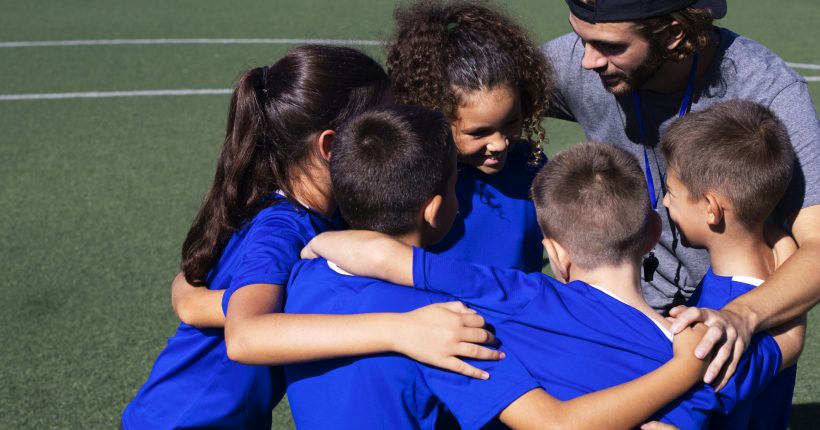 high-angle-trainer-talking-players