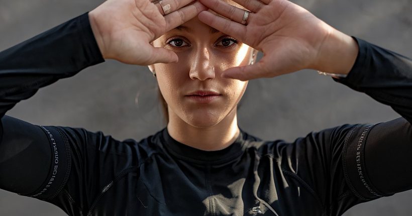 woman-with-her-hands-her-head-her-eyes-closed