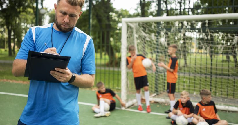 football-trainer-teaching-his-pupils