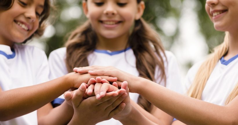 smiley-kids-putting-their-hands-each-other